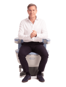 Man sitting in EMSella chair for treatment