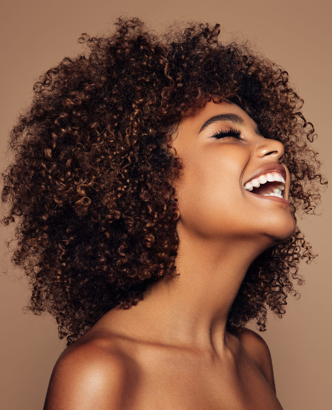 Beautiful happy woman with curly hairstyle