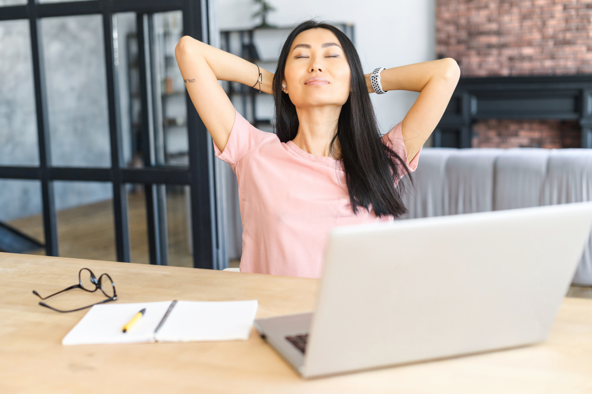 Woman Taking a Deep Relaxing Breath to Manage Stress & Cortisol Levels at work