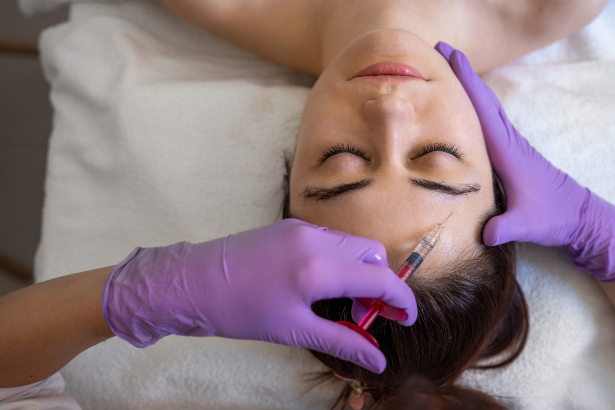 Woman getting Botox injections above her brow