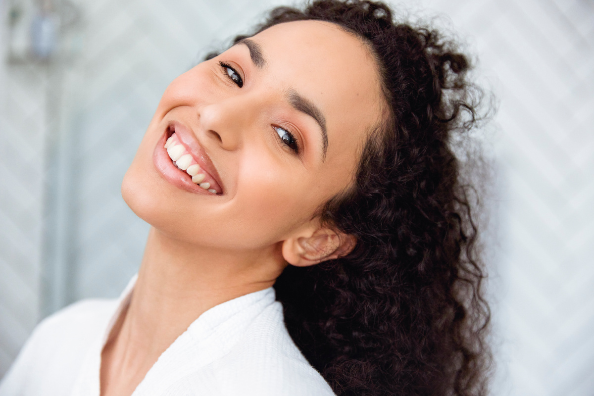 Woman with glowing skin smiling