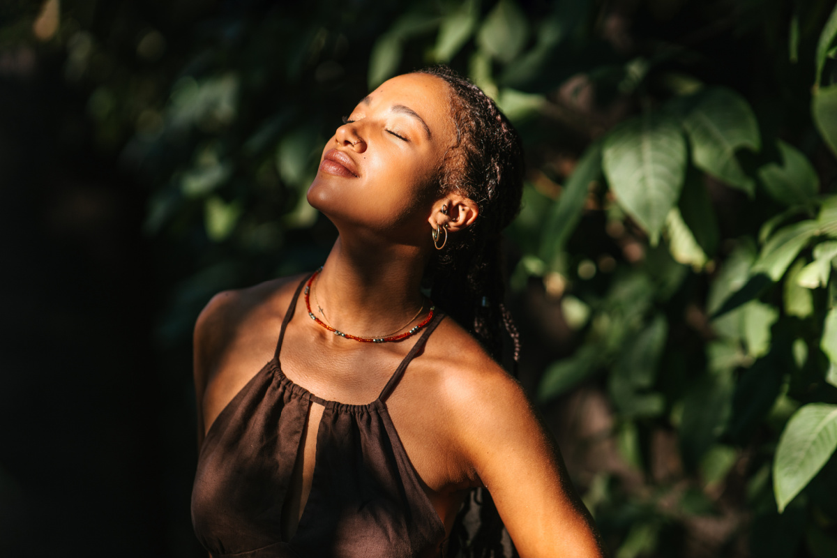 Young woman getting sun on her face for benefits to the skin